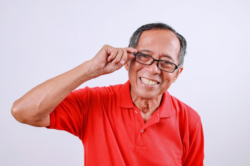 Elderly man enjoying clear vision after successful cataract surgery and lens implantation