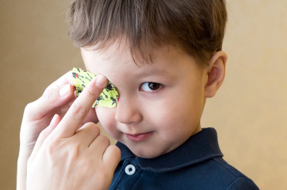 a child is wearing eye patch